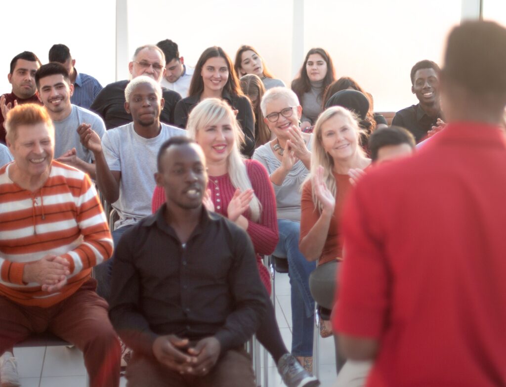 young speaker greeting the audience in the conference room.